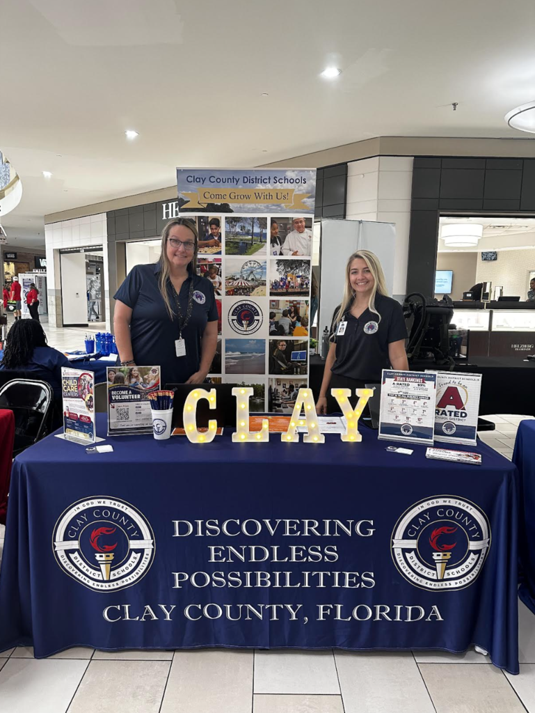 Community engagement team members working the OneClay booth at the mall 