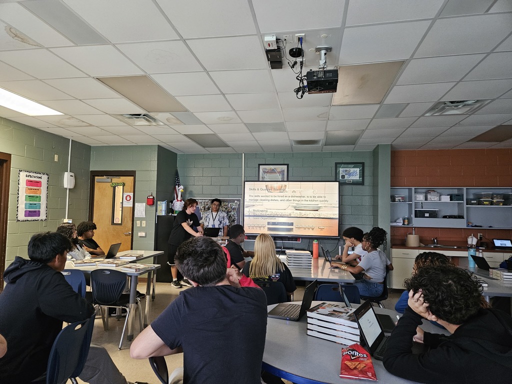 Student presenting research on a culinary career pathway while classmates listen.