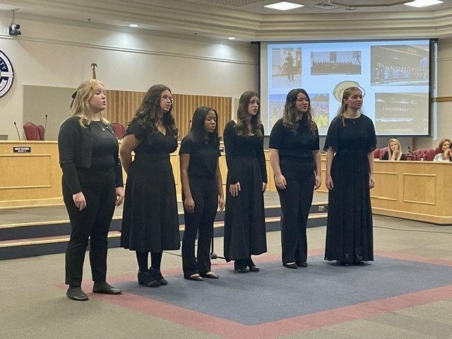 Six female students who are members of FIHS chorus singing at the TTC