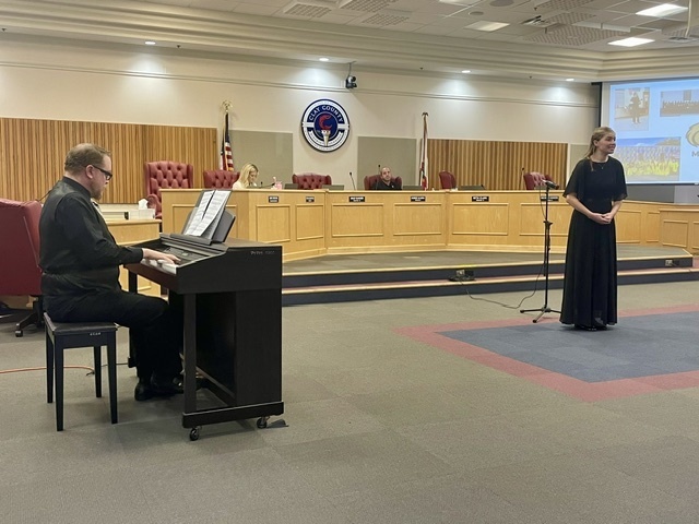 Soloist and pianist singing at the TTC board meeting
