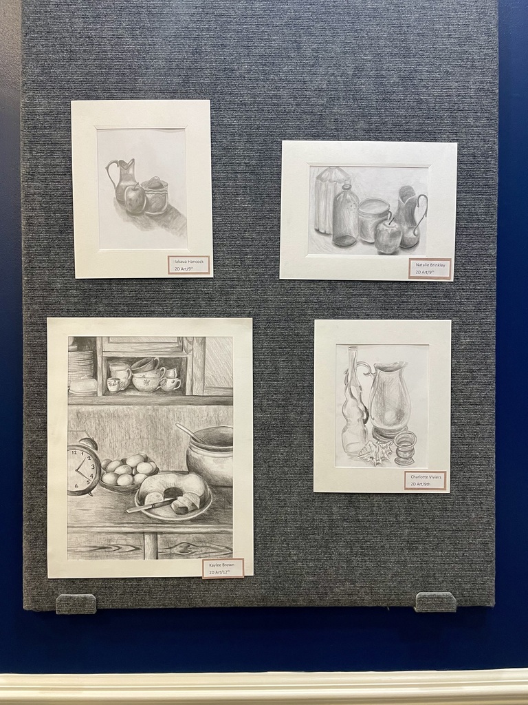 Student artwork in the TTC gallery featuring four student pieces