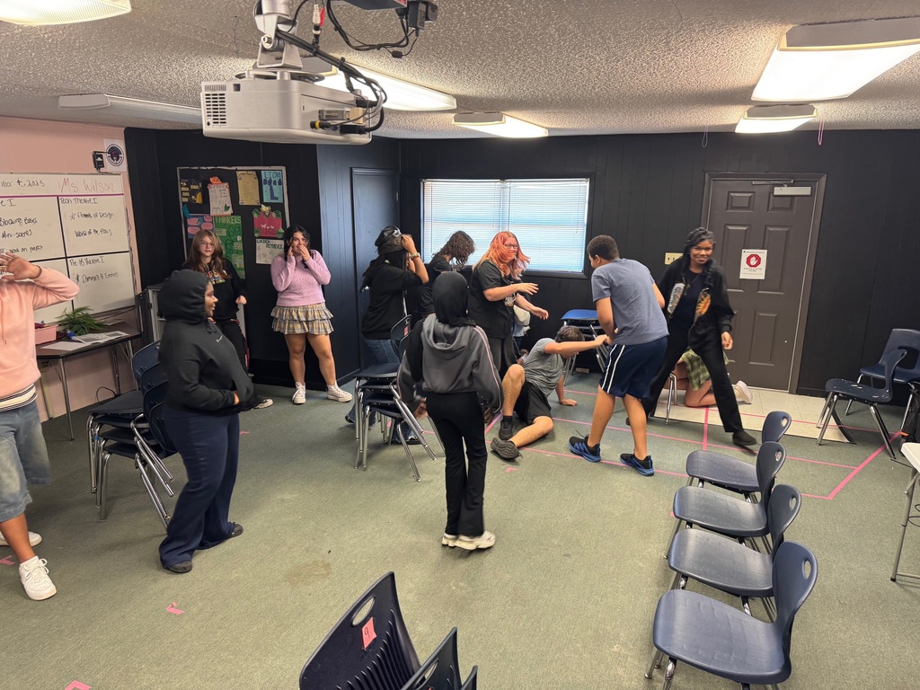 Theatre students spread out around the classroom, walking slowly while preparing to act out emotional prompts.