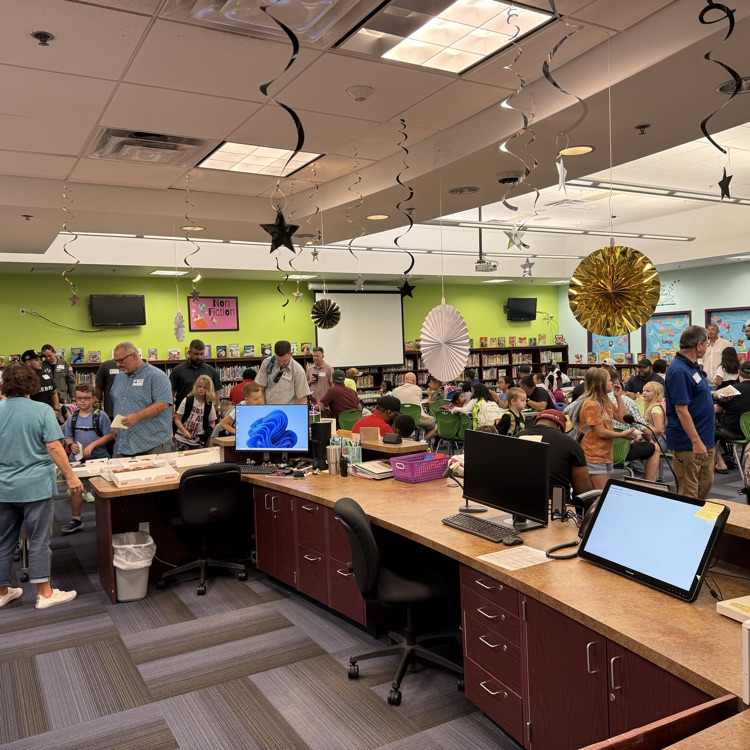 Wide view of library filled with happy people