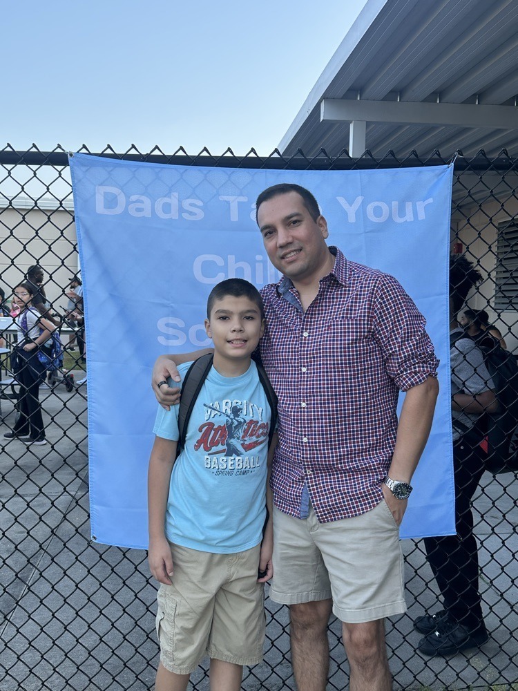 Dad and son in front of school 