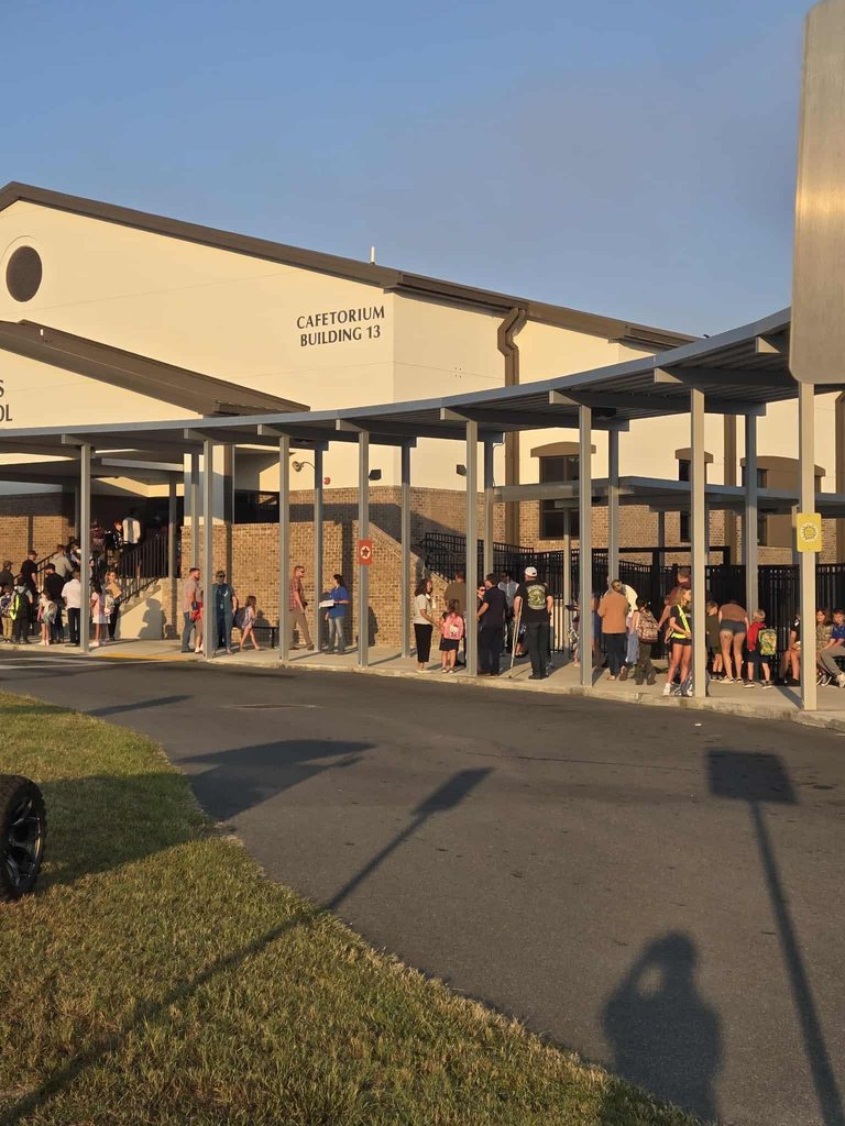 Dads lined up to walk their children to class