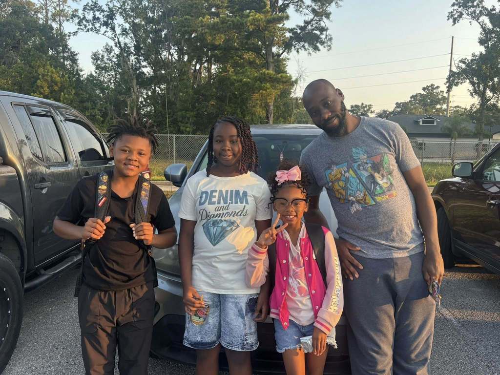 Dad walking children to classroom 