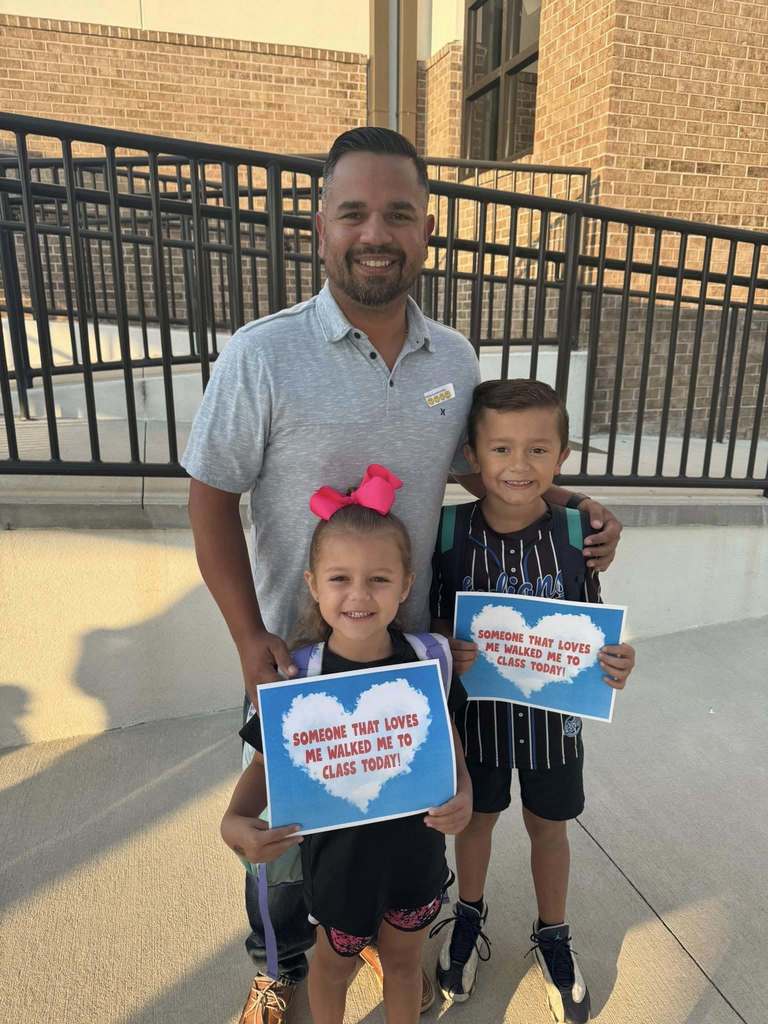 Dad walking daughter and son to class 