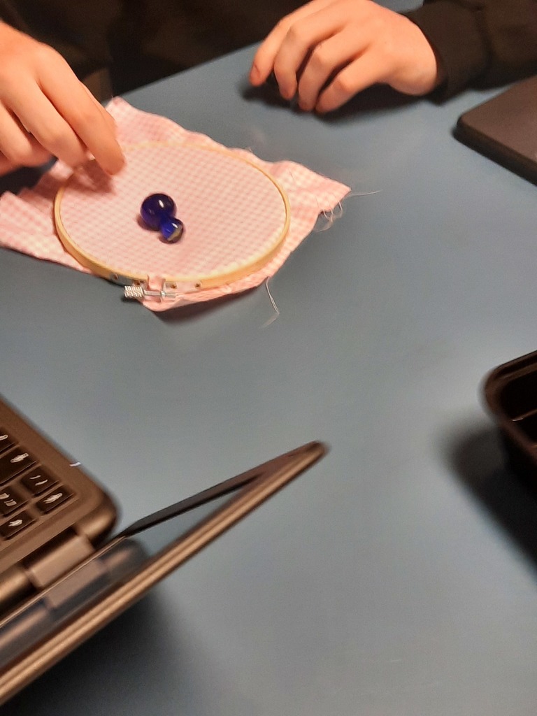 Last week, Ms. Klaes’s Astronomy students brought Einstein’s General Relativity to life through an interactive experiment! Using fabric to represent spacetime and marbles to represent planets, students observed firsthand how mass causes spacetime to curve, creating gravity. This hands-on exploration helped students connect complex physics concepts to real-world models, deepening their understanding of how our universe works.