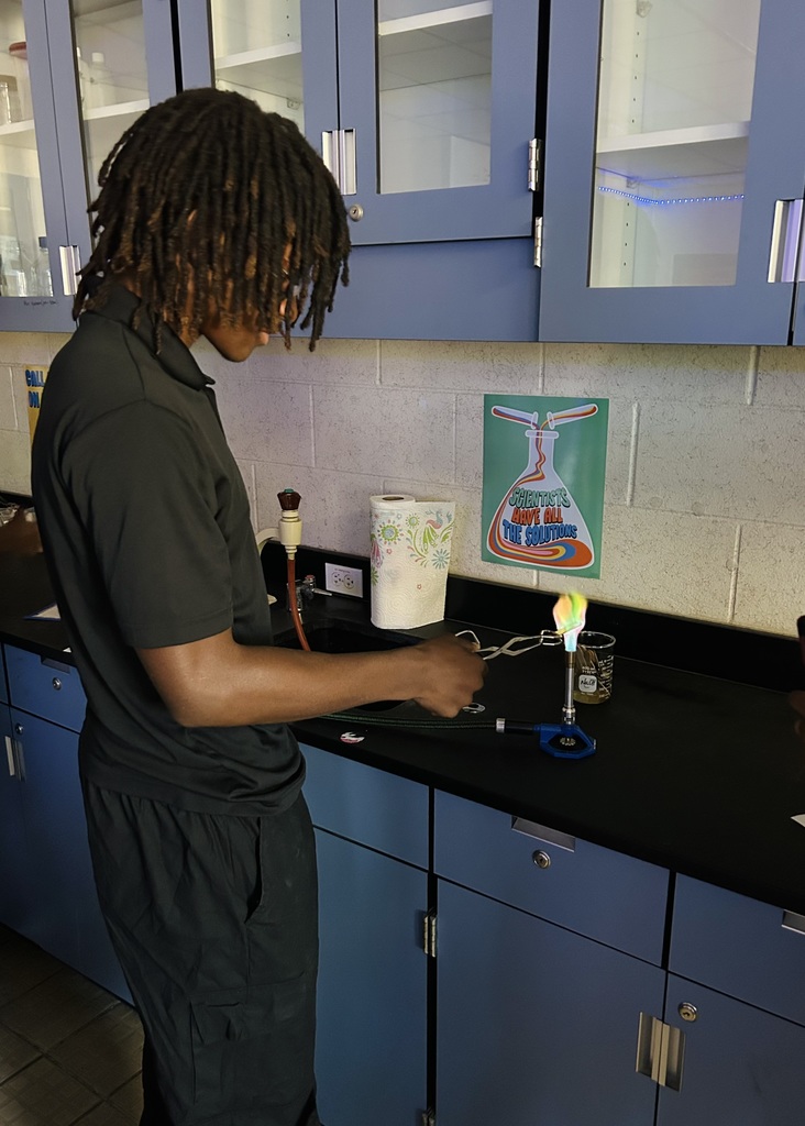 In Ms. Fortner’s Honors and Pre-IB/AICE Chemistry classes, students brought science to life through a flame test lab using Bunsen burners and various metal solutions. When heated, the electrons in each metal moved from their ground state to an excited state, then released energy in the form of vibrant light as they returned to ground state. Each colorful flame revealed a unique spectral signature for the metal ion tested, allowing students to connect abstract atomic theory to real-world observation.