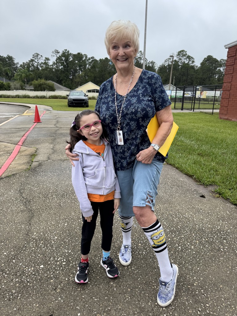Mrs. Carver and a student wearing crazy socks.