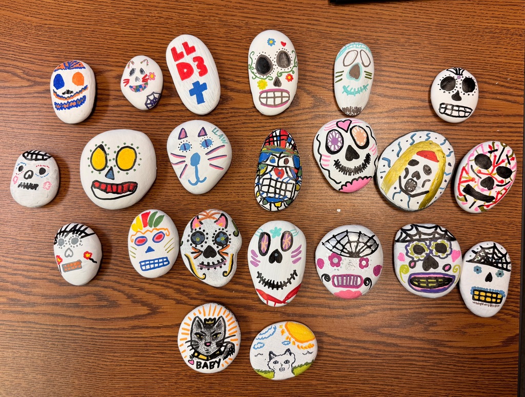 Students in Ms. Marrero’s Spanish 2 and AICE 2 classes celebrated Día de los Muertos by decorating remembrance stones dedicated to loved ones, pets, or admired figures who have passed away. As part of this cultural exploration, students expressed their emotions and described their creative process entirely in Spanish, using familiar vocabulary and new descriptive phrases. Through this experience, they deepened their language skills while connecting the rich traditions, symbols, and meanings of Día de los Muertos to their own lives.