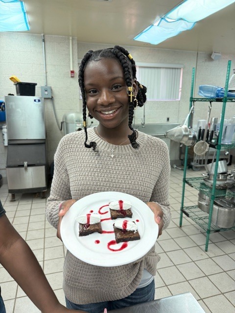 Ms. LaPierre’s Culinary 2 students are refining their plating and presentation skills, turning simple desserts into edible works of art! Students prepared rich brownies topped with a vibrant berry coulis, practicing precision, balance, and design to create visually stunning (and delicious!) plates. Their attention to detail and creativity truly showcase the artistry behind professional culinary presentation. 