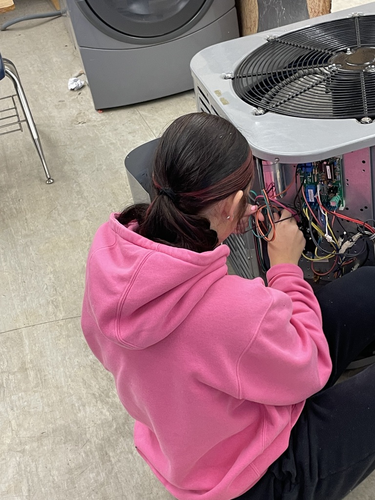 Freshman HVAC 1 student April F. is already gaining real-world experience as she works to disconnect the fan motor and remove it from the unit. This hands-on practice allows her to apply technical knowledge and build the skills needed for future success in the field!