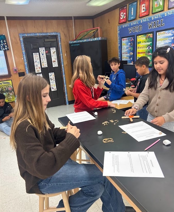 6th grade and Kindergarten have both been working on Force and Motion this quarter. Today they paired up in our Science Lab to use catapults, built by 6th graders, to launch cotton balls at targets with our K friends….It was awesome!
