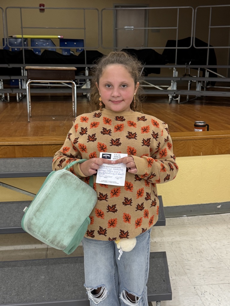 Student holding SOAR Award