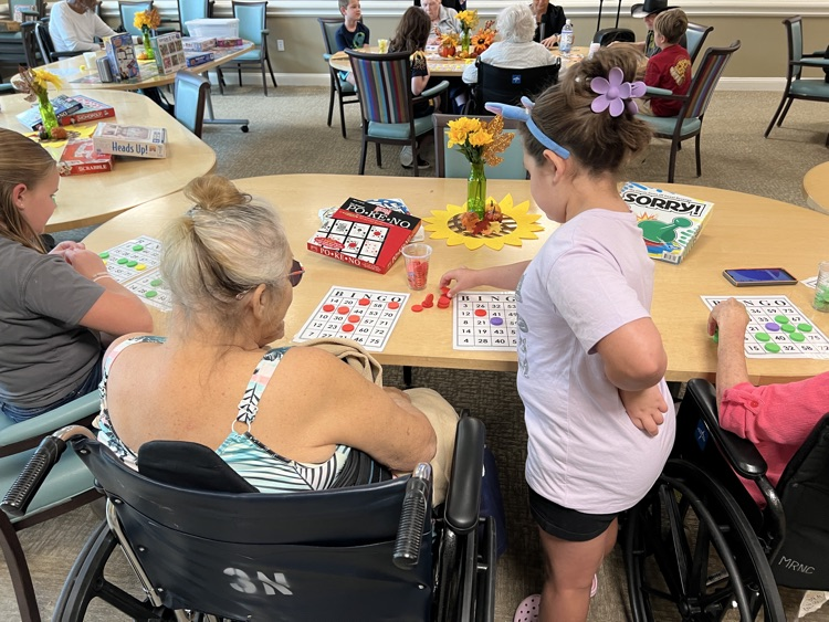 students playing bingo with residents