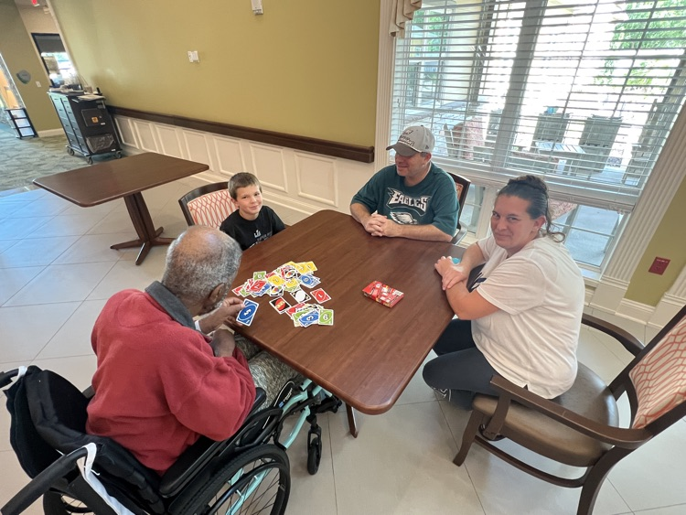students playing cards with residents