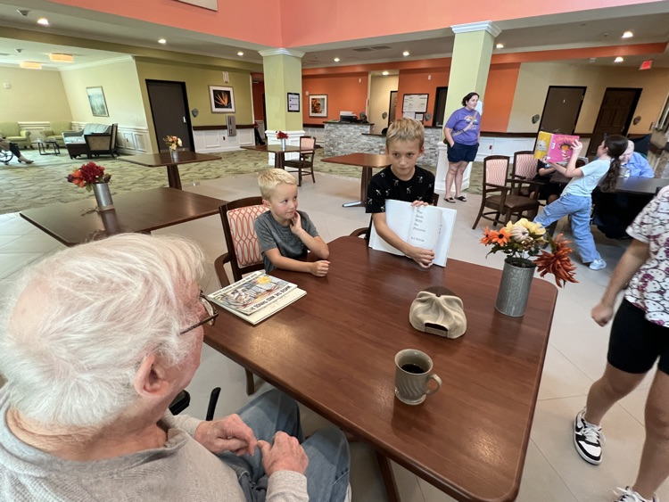 students reading with residents