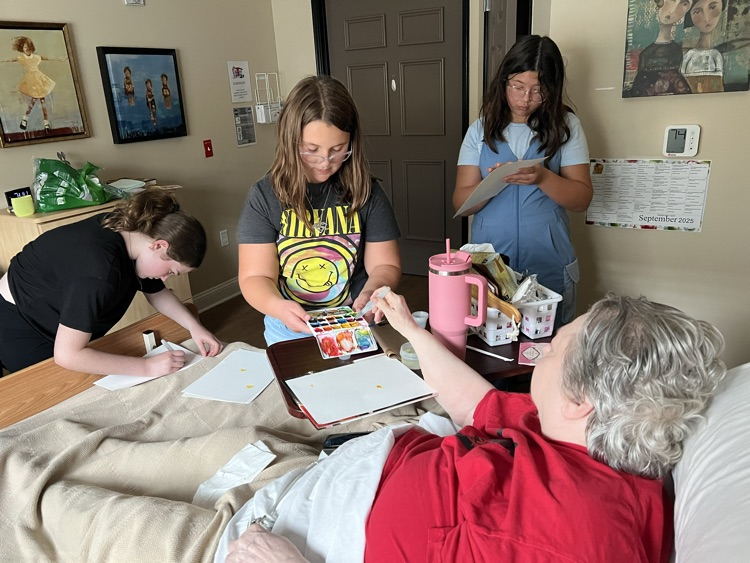 students doing art with residents