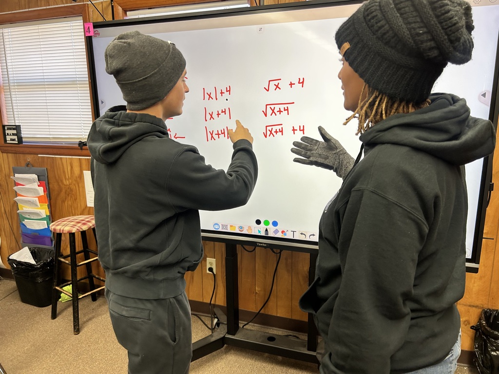 Ms. Charles’s Algebra II students were actively engaged in learning how to graph parabolas and quadratic equations, using strategies designed to help them efficiently tackle SAT-style questions. Through visual models and guided practice, students strengthened their understanding of how equations translate to graphs.  A highlight of the lesson was seeing a student step into a leadership role by explaining the math and reasoning behind the graphs to AP Williams, demonstrating both confidence and deep understanding.  Great examples of rigorous instruction, student ownership, and meaningful math discourse at Ridgeview! 🐾📐
