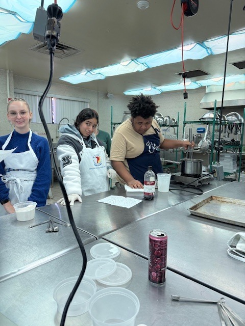 Culinary students in 3 and 4 took on a sweet, multi-day project, crafting homemade ice cream sandwiches from start to finish. On day one, students prepared their ice cream base and mise-en-place for their cookies. Day two focused on churning the ice cream, freezing it on sheet pans, and baking fresh cookies. On the final day, students used cookie cutters to shape the ice cream, assembled their sandwiches, and finished them off with a chocolate dip, bringing creativity, precision, and delicious results together.