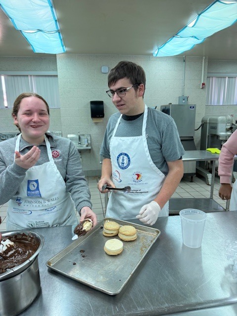Culinary students in 3 and 4 took on a sweet, multi-day project, crafting homemade ice cream sandwiches from start to finish. On day one, students prepared their ice cream base and mise-en-place for their cookies. Day two focused on churning the ice cream, freezing it on sheet pans, and baking fresh cookies. On the final day, students used cookie cutters to shape the ice cream, assembled their sandwiches, and finished them off with a chocolate dip, bringing creativity, precision, and delicious results together.