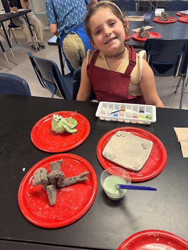 student at clay camp with projects