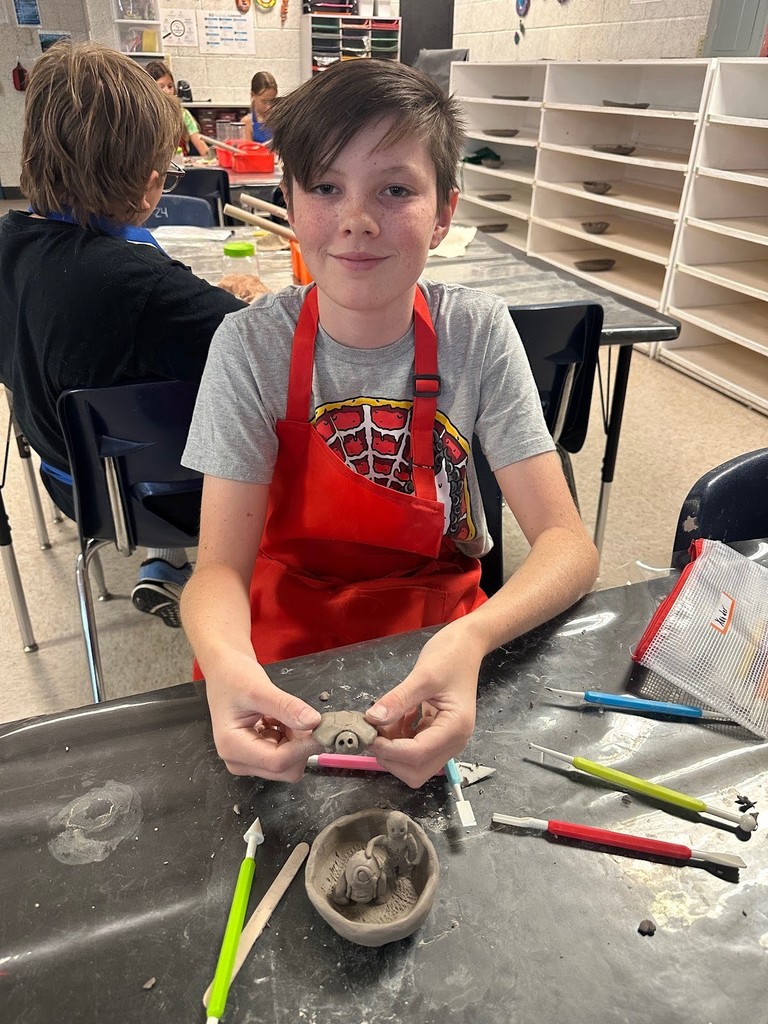 student at clay camp with projects