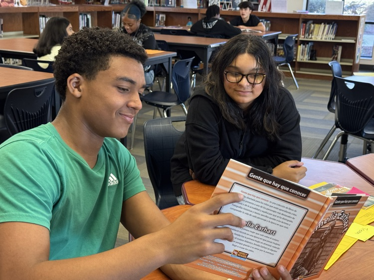 student reading a text to a peer