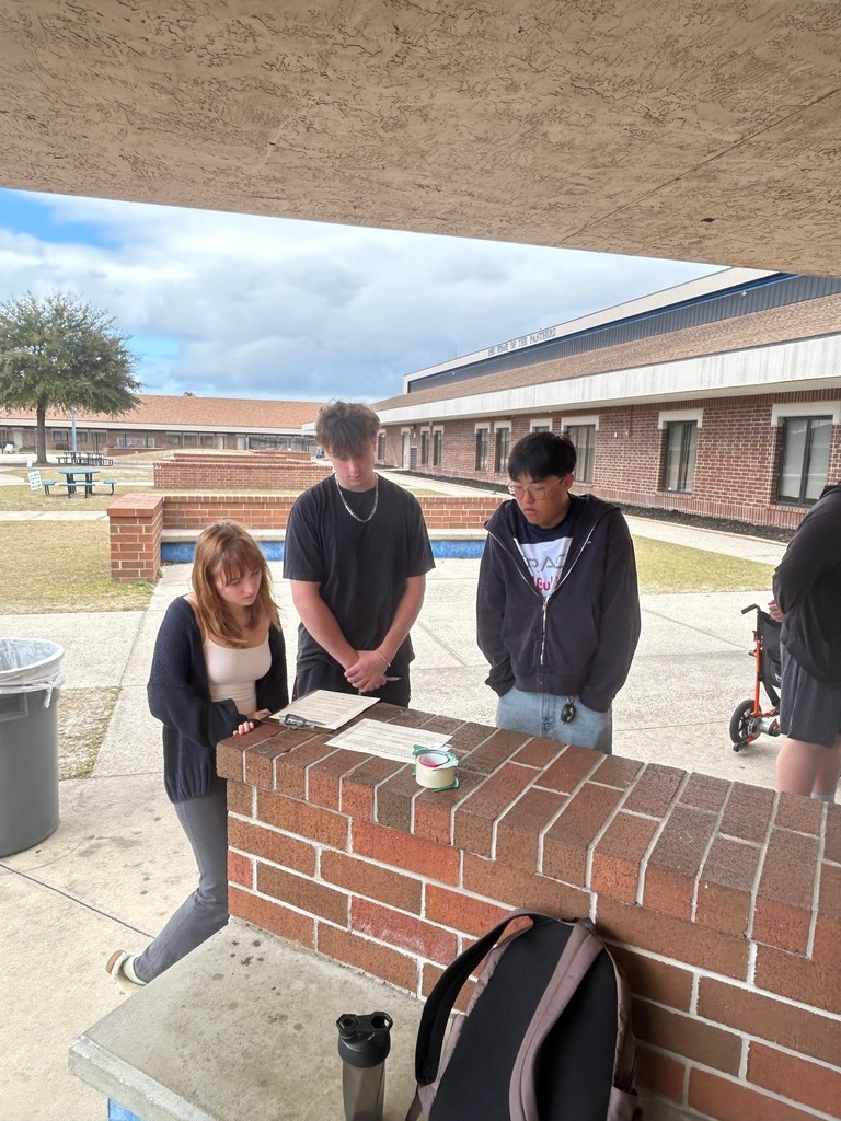 Mr. Ley’s IB Digital Society students took their learning to the courtyard as they worked collaboratively to analyze real-world ethical issues connected to Information Technology in preparation for their IB Digital Society exam. Students discussed how economic factors such as externalities, tariffs, trade-offs, net neutrality, and digital graveyards influence network decisions and their broader impact on society. Through discussion, debate, and problem-solving, students connected new concepts to prior learning, demonstrating their ability to think critically and apply knowledge across disciplines.