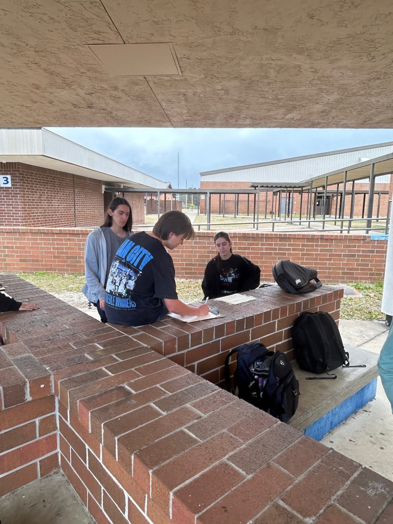 Mr. Ley’s IB Digital Society students took their learning to the courtyard as they worked collaboratively to analyze real-world ethical issues connected to Information Technology in preparation for their IB Digital Society exam. Students discussed how economic factors such as externalities, tariffs, trade-offs, net neutrality, and digital graveyards influence network decisions and their broader impact on society. Through discussion, debate, and problem-solving, students connected new concepts to prior learning, demonstrating their ability to think critically and apply knowledge across disciplines.