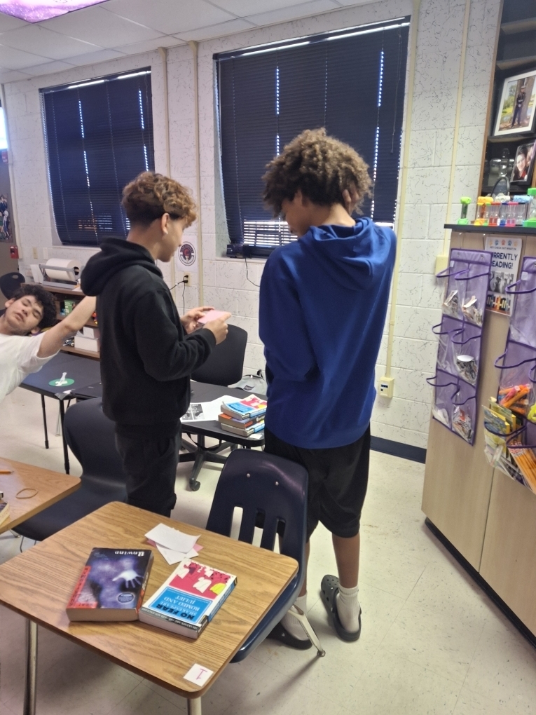 Students in Ms. Dupont’s 9th-grade English class recently brought Romeo and Juliet to life through thoughtful discussion and debate. As they prepared to write their argumentative essays, students began by creating their own personal definitions of love before gathering textual evidence to support two perspectives: whether Romeo and Juliet shared true love or their relationship was not authentic. Using color-coded index cards, students recorded quotes and explanations for both sides, then worked with a partner to debate the strength of each argument. After reaching a consensus, pairs selected a quote and explanation to display on poster paper for their classmates to review. This engaging activity helped students strengthen their critical thinking, collaboration, and evidence-based writing skills.