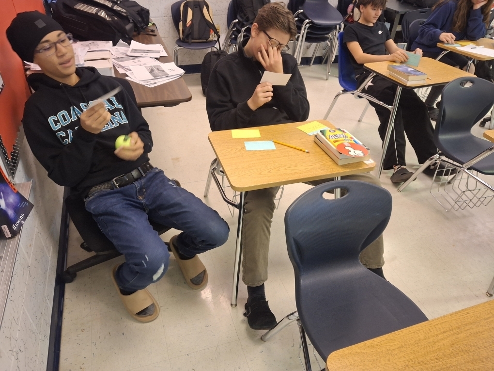 Students in Ms. Dupont’s 9th-grade English class recently brought Romeo and Juliet to life through thoughtful discussion and debate. As they prepared to write their argumentative essays, students began by creating their own personal definitions of love before gathering textual evidence to support two perspectives: whether Romeo and Juliet shared true love or their relationship was not authentic. Using color-coded index cards, students recorded quotes and explanations for both sides, then worked with a partner to debate the strength of each argument. After reaching a consensus, pairs selected a quote and explanation to display on poster paper for their classmates to review. This engaging activity helped students strengthen their critical thinking, collaboration, and evidence-based writing skills.