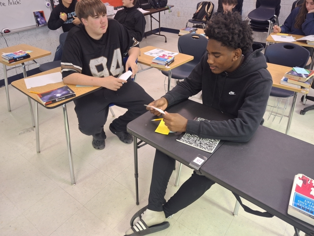 Students in Ms. Dupont’s 9th-grade English class recently brought Romeo and Juliet to life through thoughtful discussion and debate. As they prepared to write their argumentative essays, students began by creating their own personal definitions of love before gathering textual evidence to support two perspectives: whether Romeo and Juliet shared true love or their relationship was not authentic. Using color-coded index cards, students recorded quotes and explanations for both sides, then worked with a partner to debate the strength of each argument. After reaching a consensus, pairs selected a quote and explanation to display on poster paper for their classmates to review. This engaging activity helped students strengthen their critical thinking, collaboration, and evidence-based writing skills.