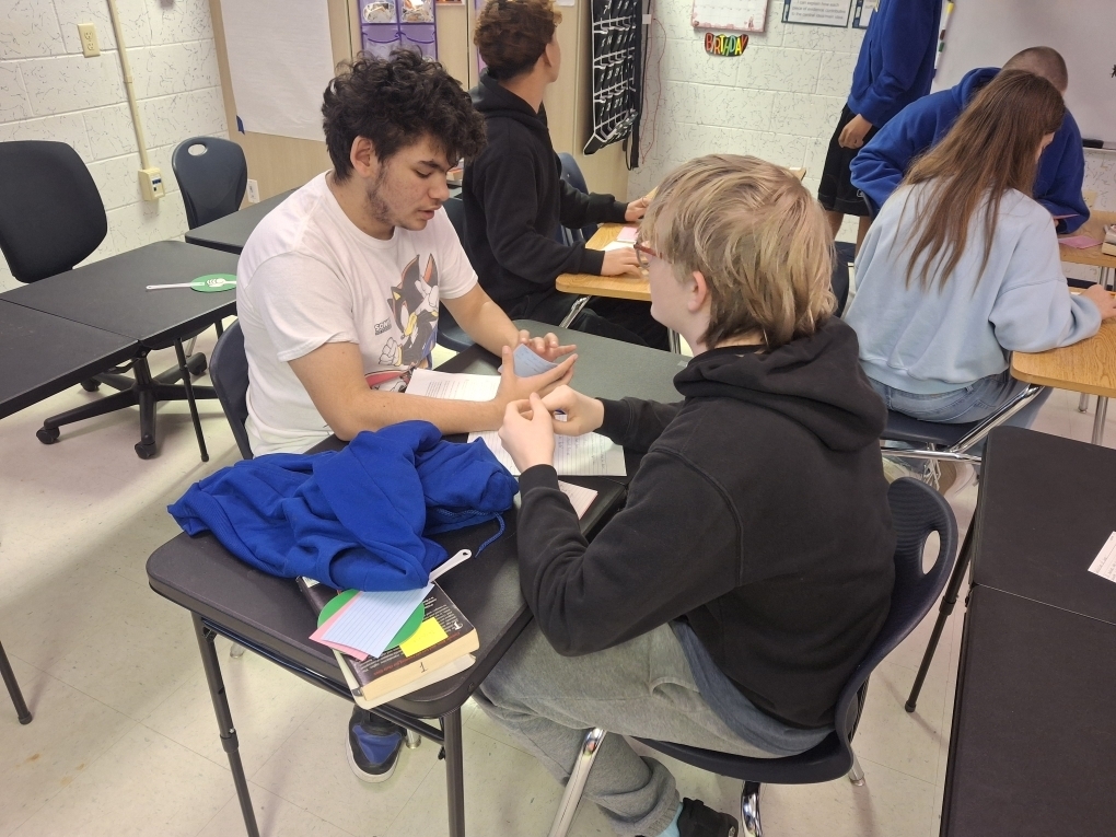 Students in Ms. Dupont’s 9th-grade English class recently brought Romeo and Juliet to life through thoughtful discussion and debate. As they prepared to write their argumentative essays, students began by creating their own personal definitions of love before gathering textual evidence to support two perspectives: whether Romeo and Juliet shared true love or their relationship was not authentic. Using color-coded index cards, students recorded quotes and explanations for both sides, then worked with a partner to debate the strength of each argument. After reaching a consensus, pairs selected a quote and explanation to display on poster paper for their classmates to review. This engaging activity helped students strengthen their critical thinking, collaboration, and evidence-based writing skills.