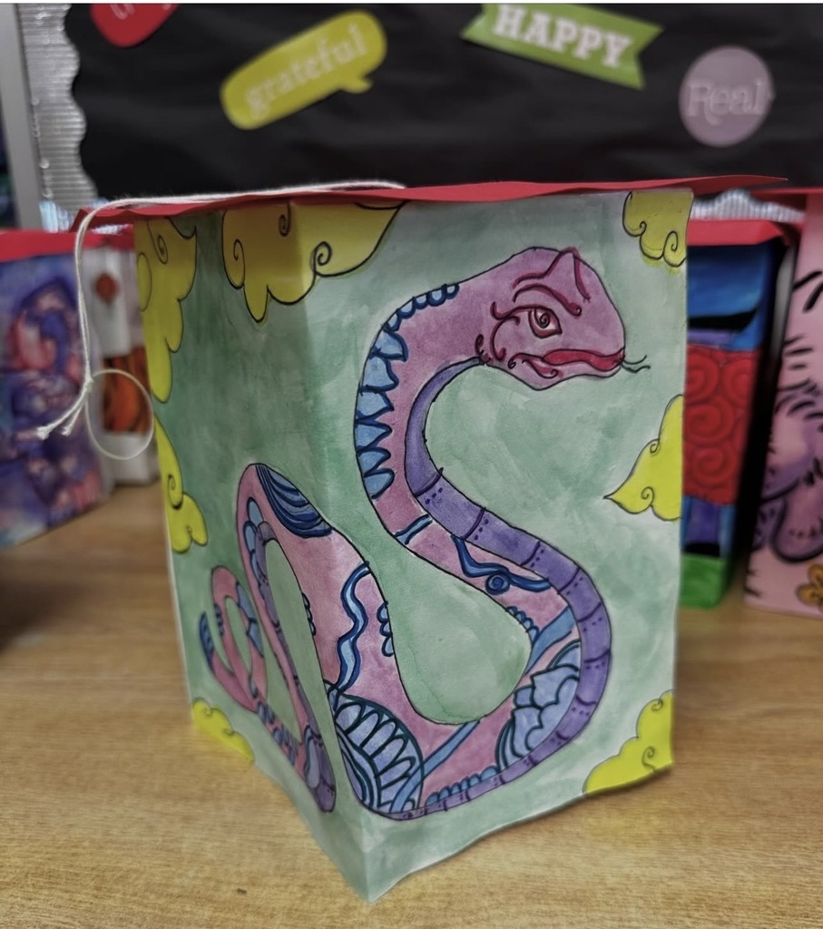 Ms. Generazio’s Art 2 students recently explored the traditions of the Chinese New Year while creating beautiful lantern projects inspired by the celebration. After learning about the cultural significance and symbolism of lanterns, students designed their own using watercolor and marker to bring their ideas to life.  The finished pieces showcase vibrant colors, detailed line work, and creative designs—from powerful tigers to beautifully patterned snakes and floral elements. By combining watercolor techniques with marker illustration, students were able to add depth, contrast, and intricate detail to their artwork.  Projects like this allow students to strengthen their artistic skills while also learning about traditions from around the world.
