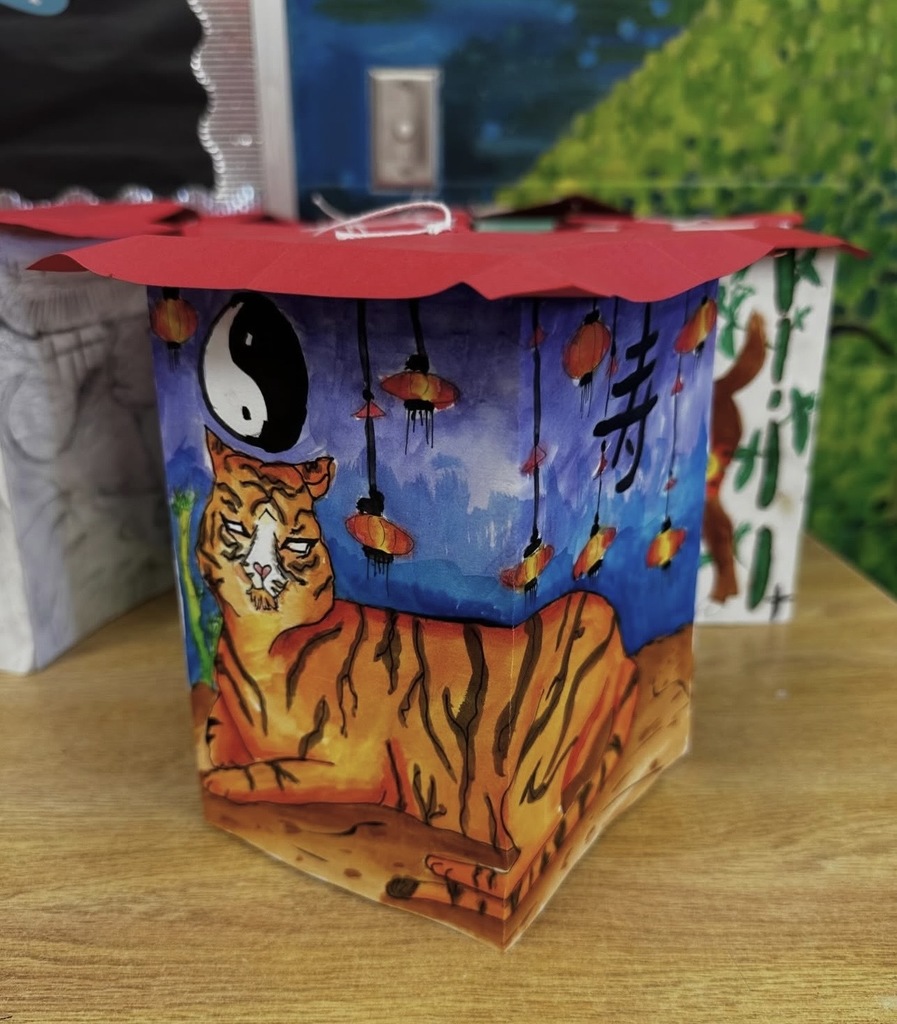 Ms. Generazio’s Art 2 students recently explored the traditions of the Chinese New Year while creating beautiful lantern projects inspired by the celebration. After learning about the cultural significance and symbolism of lanterns, students designed their own using watercolor and marker to bring their ideas to life.  The finished pieces showcase vibrant colors, detailed line work, and creative designs—from powerful tigers to beautifully patterned snakes and floral elements. By combining watercolor techniques with marker illustration, students were able to add depth, contrast, and intricate detail to their artwork.  Projects like this allow students to strengthen their artistic skills while also learning about traditions from around the world.