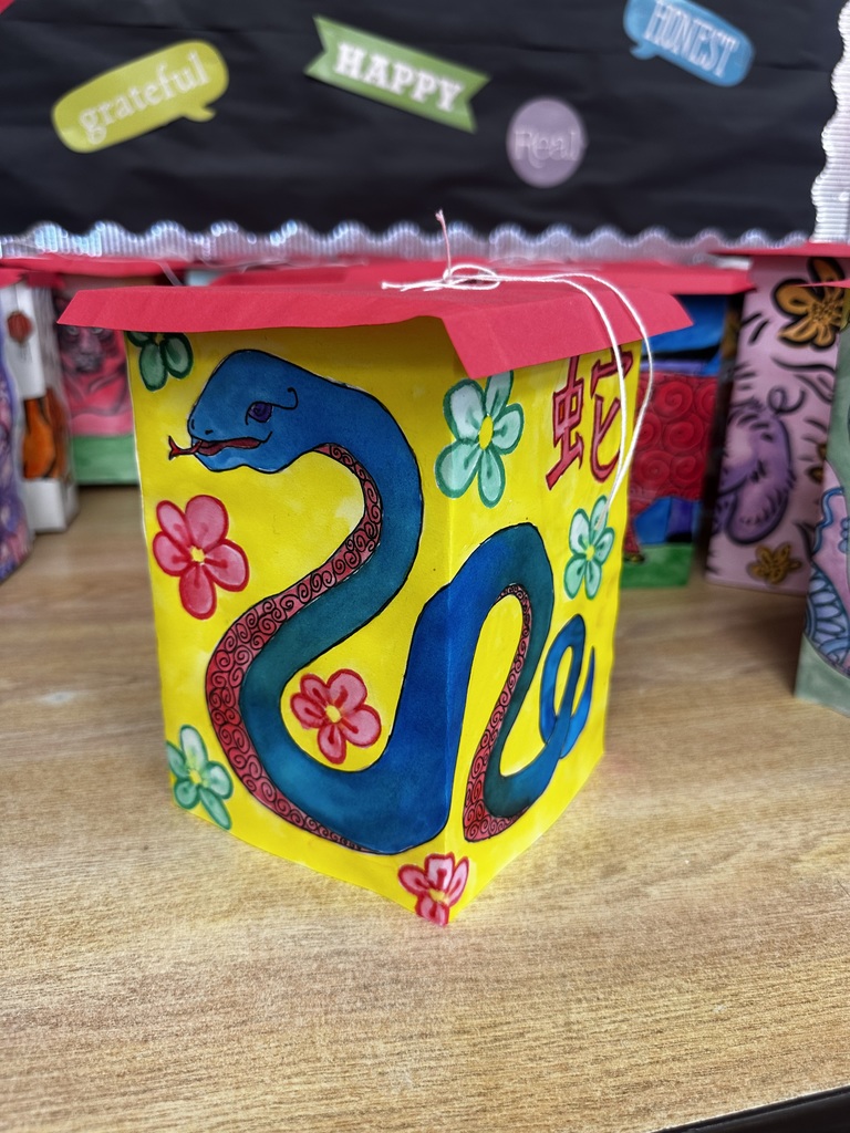 Ms. Generazio’s Art 2 students recently explored the traditions of the Chinese New Year while creating beautiful lantern projects inspired by the celebration. After learning about the cultural significance and symbolism of lanterns, students designed their own using watercolor and marker to bring their ideas to life.  The finished pieces showcase vibrant colors, detailed line work, and creative designs—from powerful tigers to beautifully patterned snakes and floral elements. By combining watercolor techniques with marker illustration, students were able to add depth, contrast, and intricate detail to their artwork.  Projects like this allow students to strengthen their artistic skills while also learning about traditions from around the world.