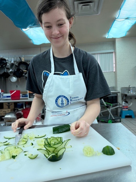 Students in Culinary 3 and 4 are sharpening their culinary artistry while learning garnishing and decorative food presentation. As part of the lesson, students practiced transforming cucumbers into delicate flower designs, building both knife skills and attention to detail. Activities like this help our Panthers understand that presentation is just as important as flavor in the culinary world while allowing them to showcase their creativity in the kitchen.