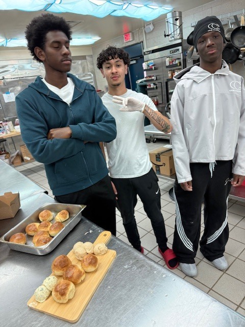 Our Culinary 3 and 4 students recently took on the challenge of creating their own bread-and-butter boards from scratch! Students began by researching a bread recipe that could be completed within two days. On day one, they prepared the dough and placed it in the refrigerator to slow the rise. On day two, they shaped and baked their loaves, then created a flavored butter of their choice. From sweet to savory, the variety of butters paired perfectly with the freshly baked bread. To finish, students arranged their creations on wooden cutting boards for a beautiful presentation. It was a hands-on lesson in patience, technique, and creativity, and the results were delicious! 