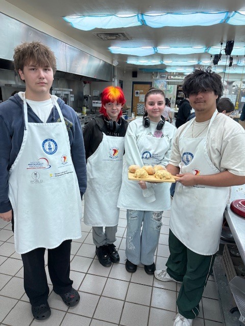Our Culinary 3 and 4 students recently took on the challenge of creating their own bread-and-butter boards from scratch! Students began by researching a bread recipe that could be completed within two days. On day one, they prepared the dough and placed it in the refrigerator to slow the rise. On day two, they shaped and baked their loaves, then created a flavored butter of their choice. From sweet to savory, the variety of butters paired perfectly with the freshly baked bread. To finish, students arranged their creations on wooden cutting boards for a beautiful presentation. It was a hands-on lesson in patience, technique, and creativity, and the results were delicious! 