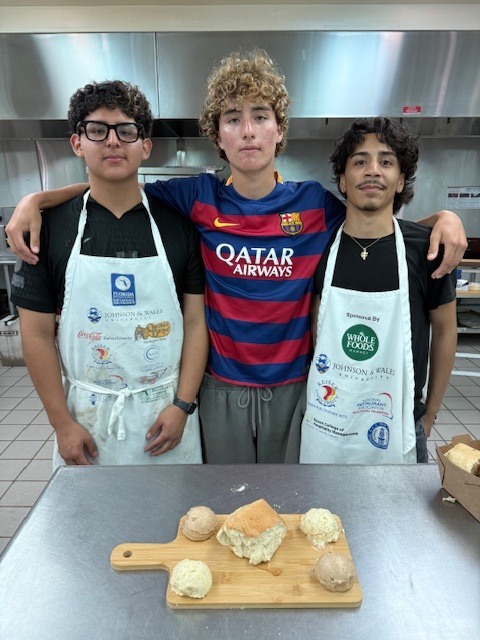 Our Culinary 3 and 4 students recently took on the challenge of creating their own bread-and-butter boards from scratch! Students began by researching a bread recipe that could be completed within two days. On day one, they prepared the dough and placed it in the refrigerator to slow the rise. On day two, they shaped and baked their loaves, then created a flavored butter of their choice. From sweet to savory, the variety of butters paired perfectly with the freshly baked bread. To finish, students arranged their creations on wooden cutting boards for a beautiful presentation. It was a hands-on lesson in patience, technique, and creativity, and the results were delicious! 