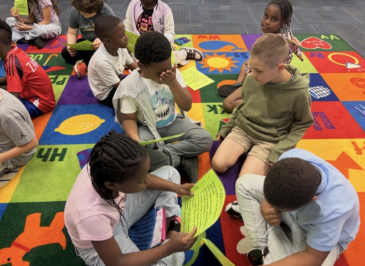 Photo of students reading in groups