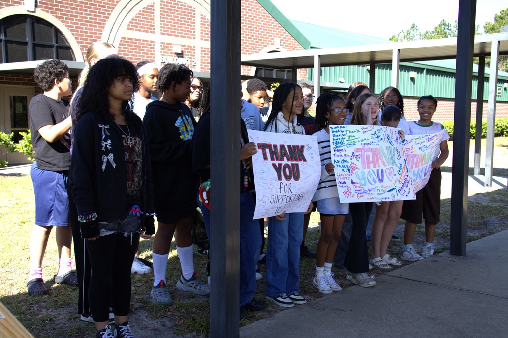Group of students holding Thank You Posters