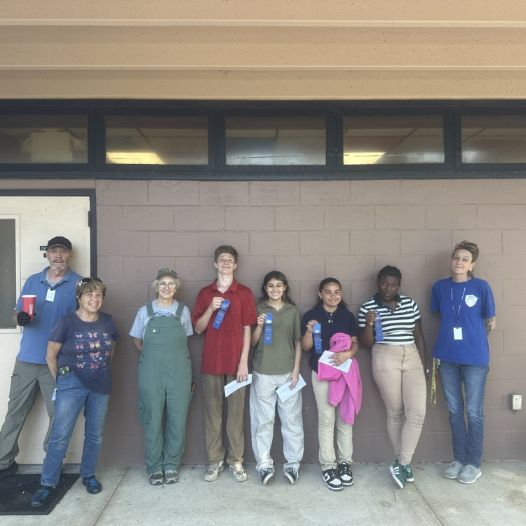 Students standing with the master gardeners with their awards from the Clay County Fair.