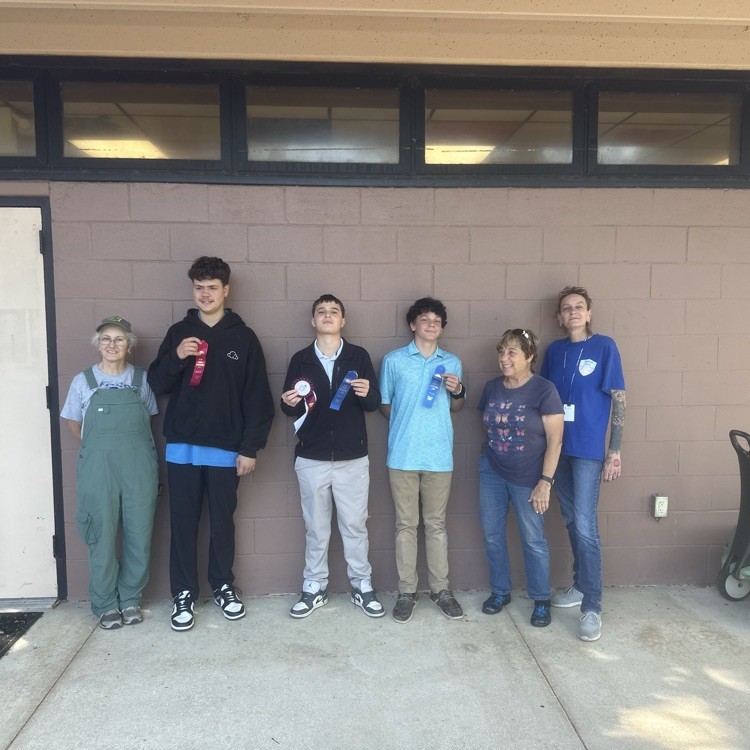 Students standing with the master gardeners with their awards from the Clay County Fair.