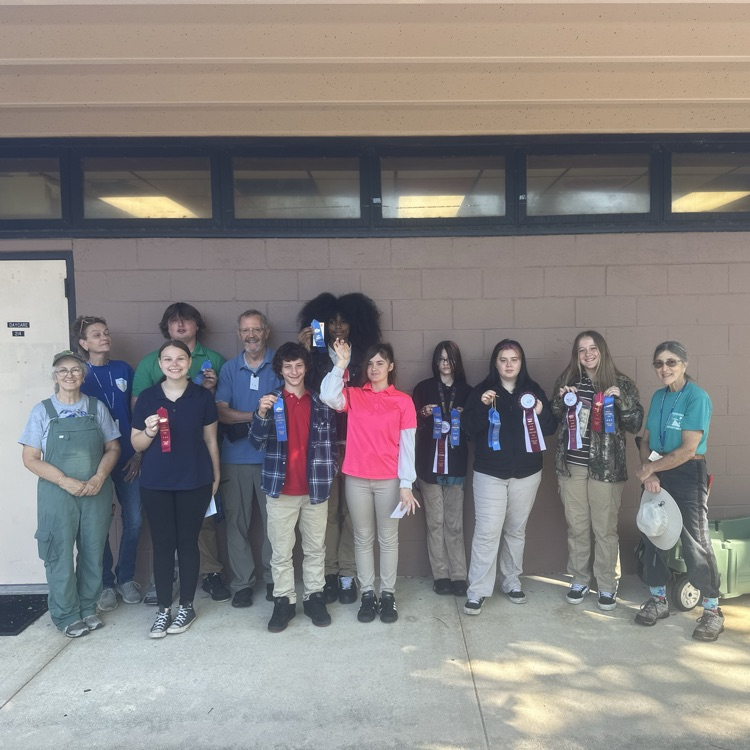 Students standing with the master gardeners with their awards from the Clay County Fair.