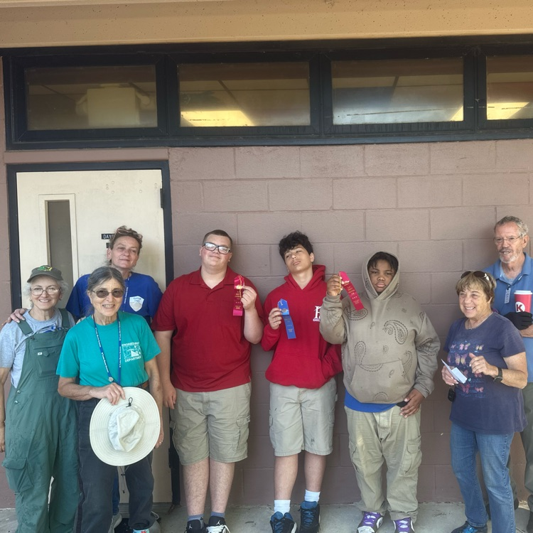Students standing with the master gardeners with their awards from the Clay County Fair.