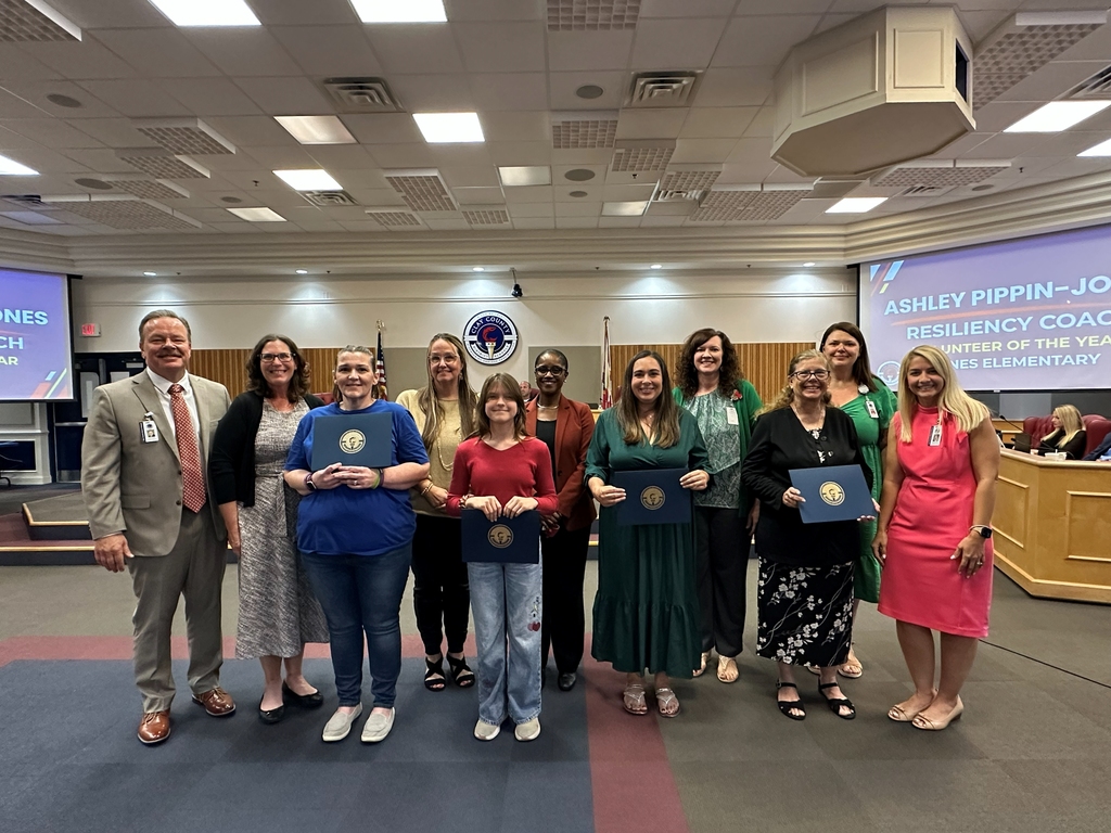 Volunteers of the year holding their certificates with district leaders at the board meeting in November 2025.