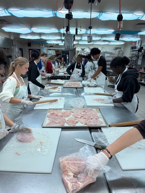 Recently, our Culinary students worked hard to prepare an incredible meal for the Clay Can Dance event. Students pounded out 250 pieces of chicken, and Mrs. Stevens’ 3rd period was a tremendous help during the preparation process while many students were away at Grad Bash.  The menu featured rolled chicken stuffed with spinach and Boursin cheese, Caprese skewers, salad, green beans, meatballs, bruschetta, molded butter, and mashed potatoes. A special thank you goes to Angelica, Mariah, and Sidney, who came in on Saturday to help finish the meal and prepare the mashed potatoes for pick up.  We are proud of the teamwork, dedication, and talent our students demonstrated, and we are so glad the guests enjoyed the meal.